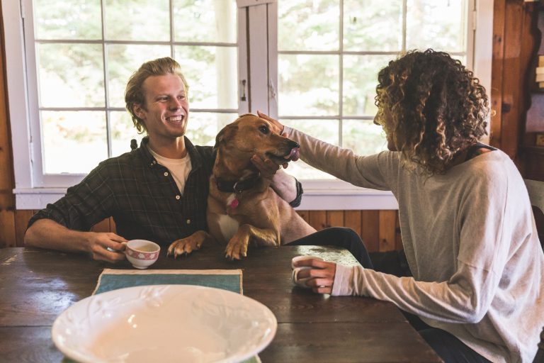 Dog and two people in a cabin.