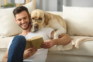 Man and dog reading a book together