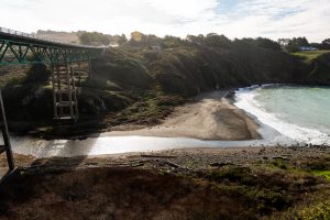 Bridge over ravine with stream leading to ocean below in Albion Ca.