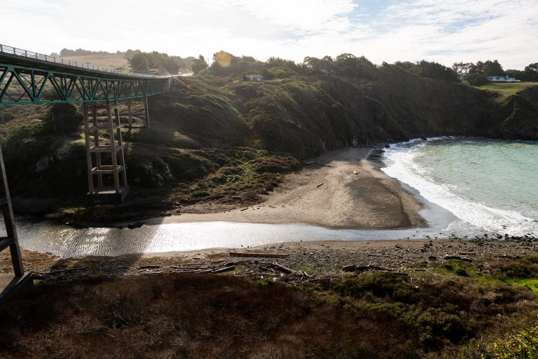 Bridge over ravine with stream leading to ocean below in Albion Ca.