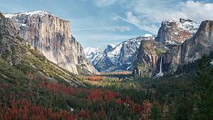 a view of Yosemite Valley with mountains in the background.
