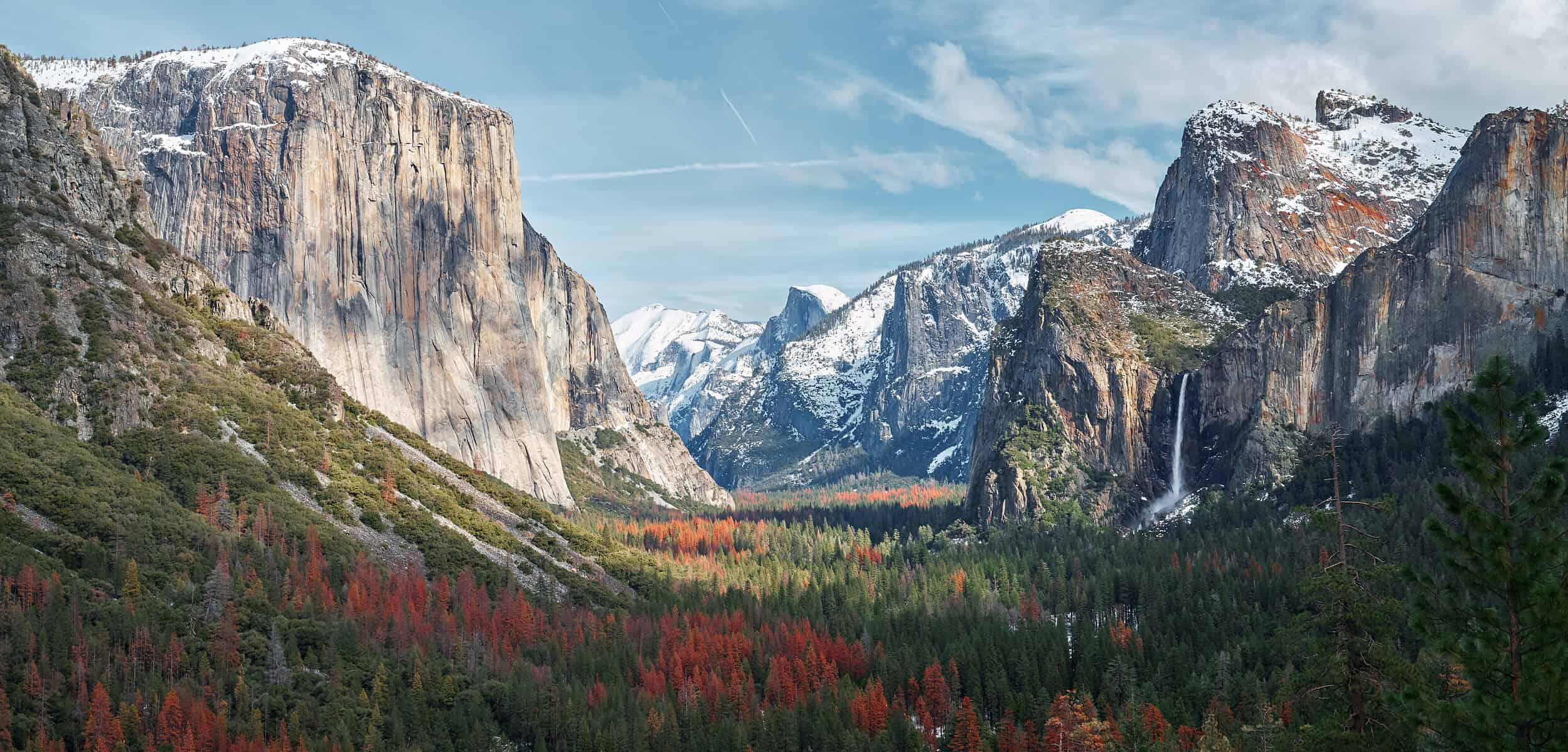 a view of Yosemite Valley with mountains in the background.