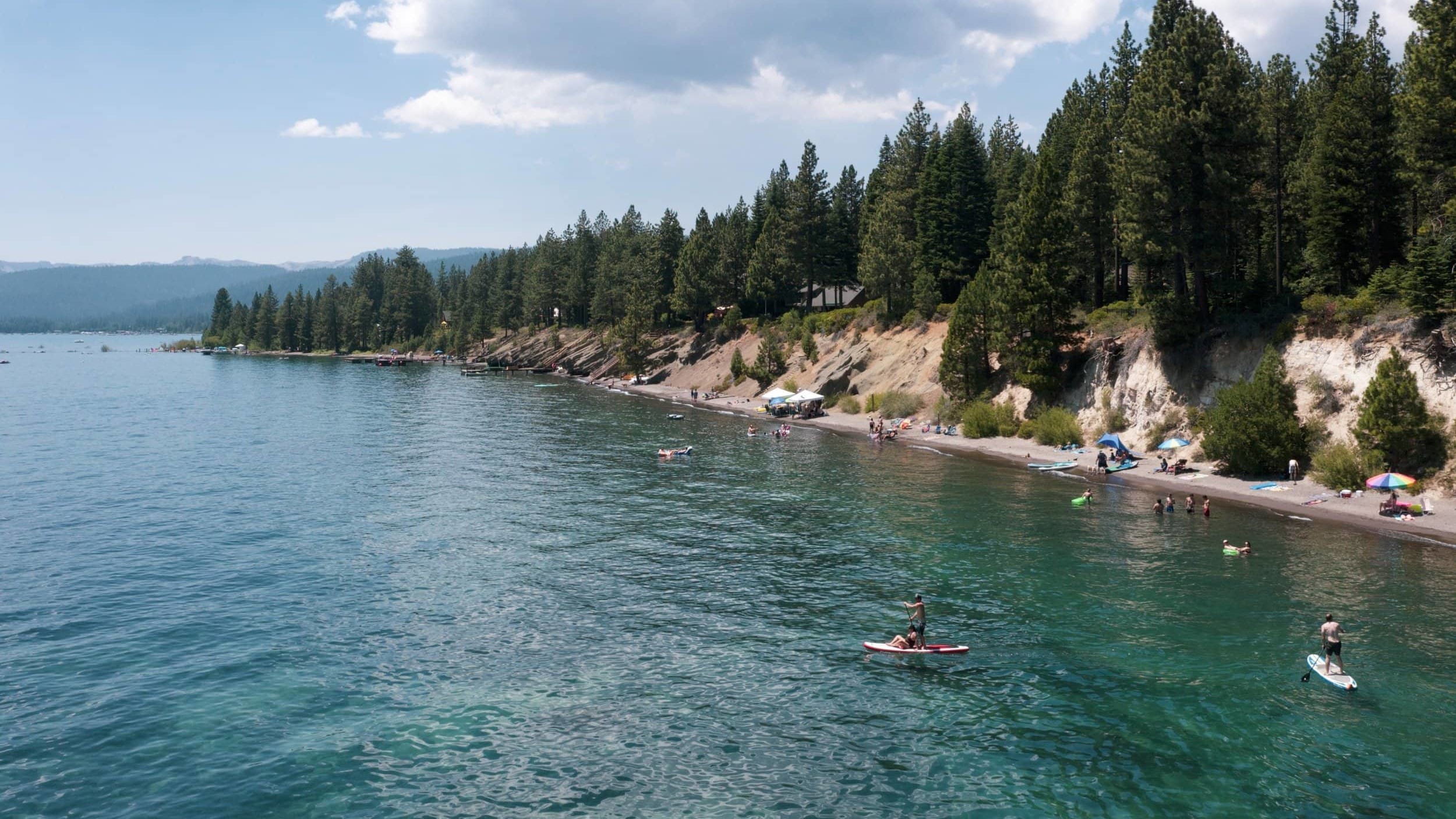 View of Lake Tahoe with paddle boarders.