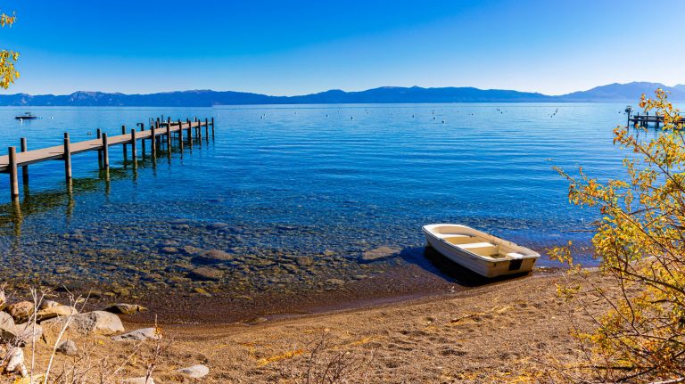 Small Boat With Dock on Pebble Beach at Hurricane Bay, Lake Tahoe, California, USA