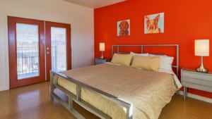 room with french doors bed and dog themed artwork