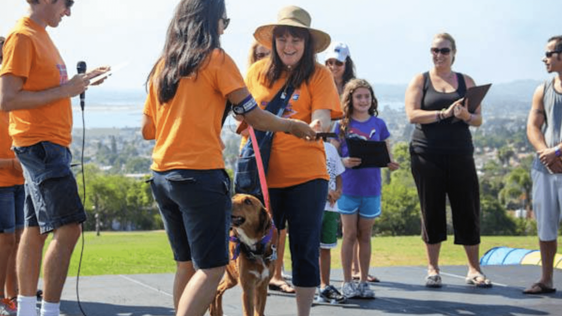 volunteers on walk with dog