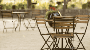 Bistro tables and chairs outside at St. Supery Estate Vineyards & Winery.