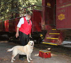 Kayla the lab and Chuck the conductor prepare to board the Skunk Train
