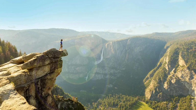Hiker at the Glacier Point with View to Yosemite Falls and Valley in the Yosemite National Park, California, USA