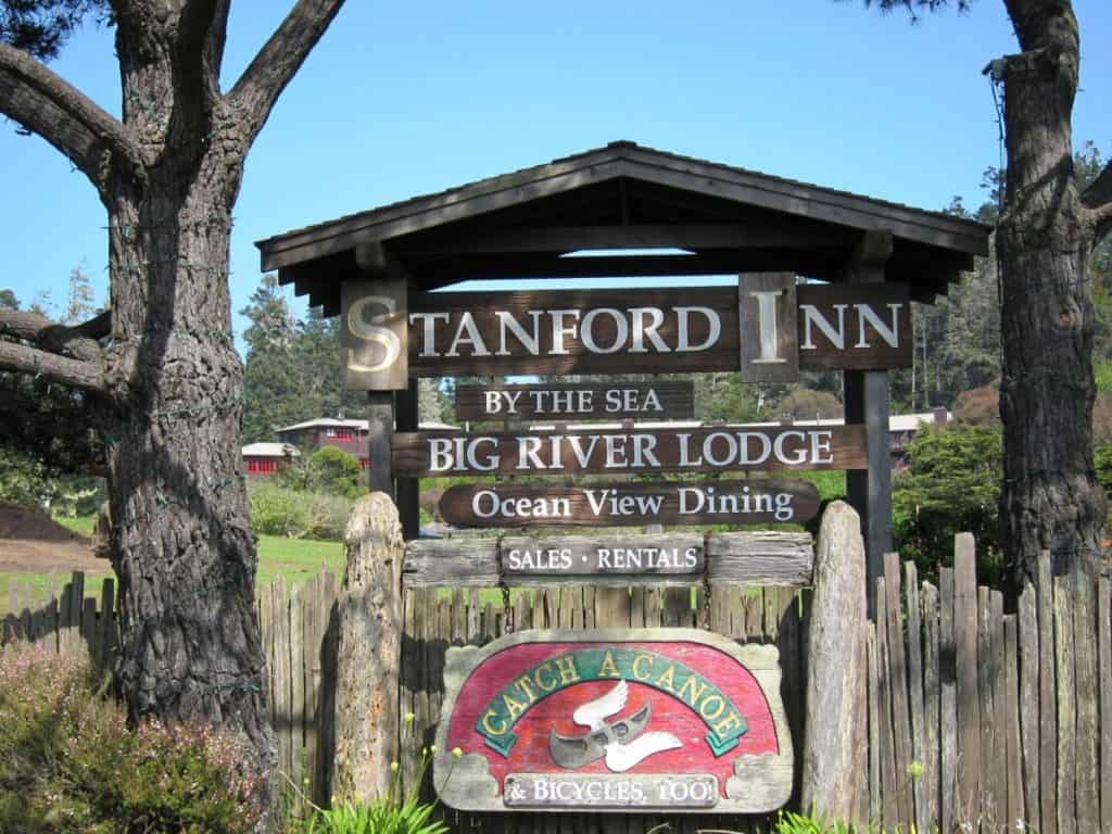 Sign reading "Stanford Inn by the Sea, Big River Lodge, Ocean View Dining, Sales, Rentals, Catch a Canoe & Bicycles Too!