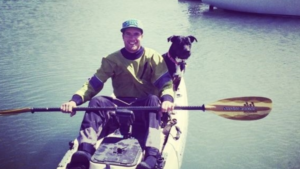 Dog and person in kayak