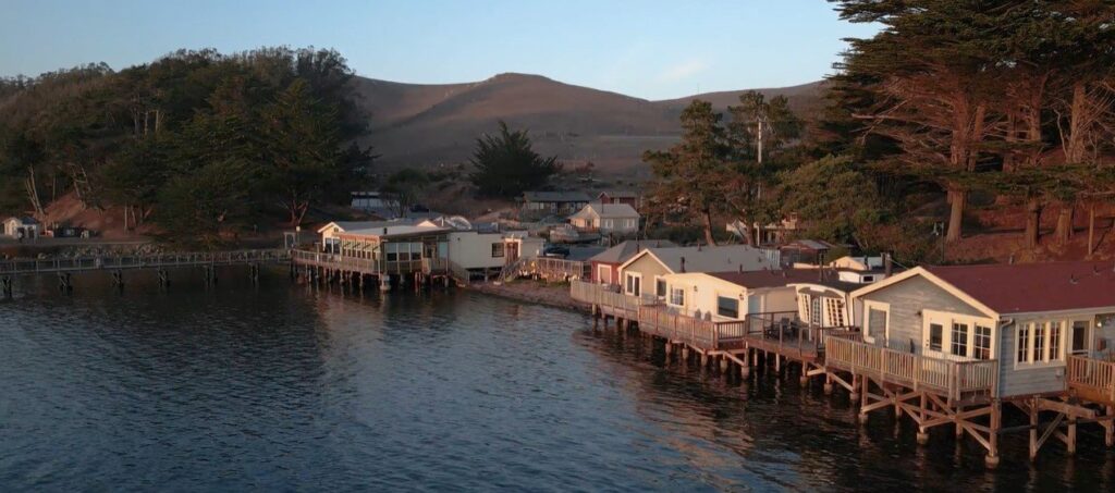 A row of houses sitting on top of a pier in Nick's Cove.