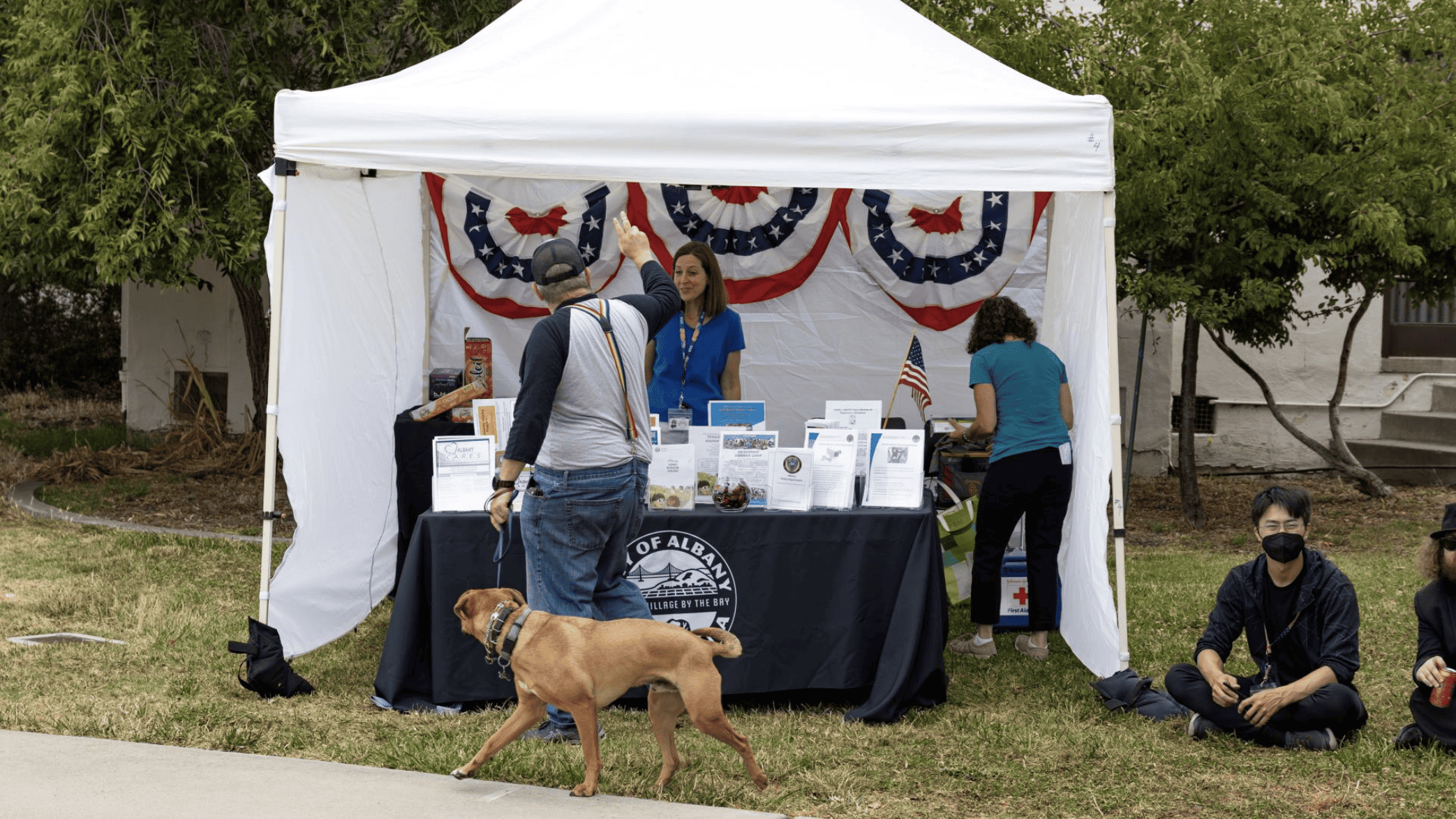 man with a dog at booth at Albany 4th of July Celebration