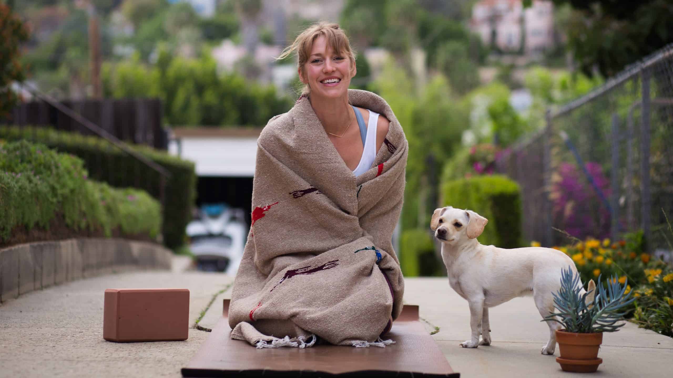 woman on yoga mat with dog