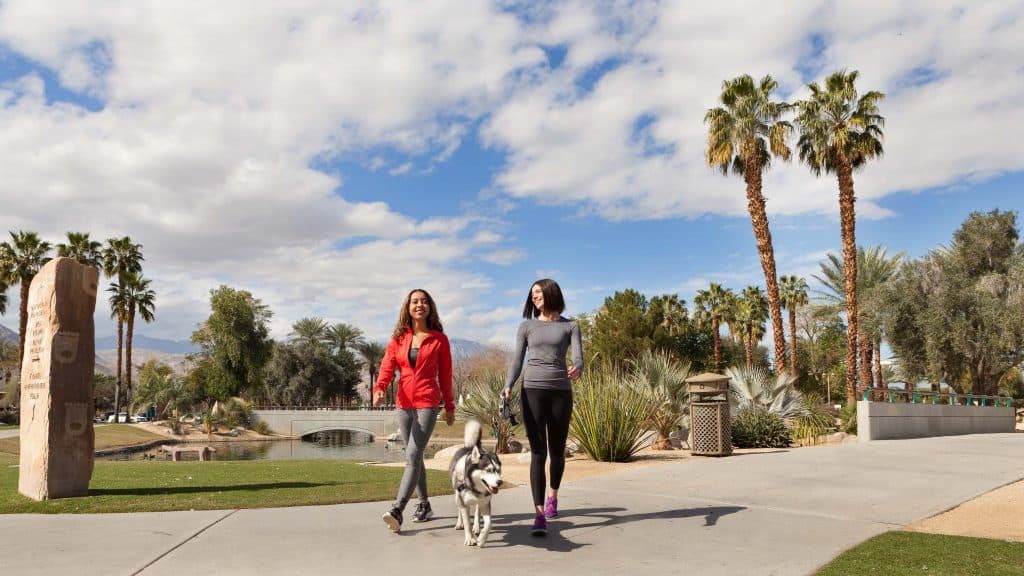 Two women hiking with a dog in Greater Palm Springs