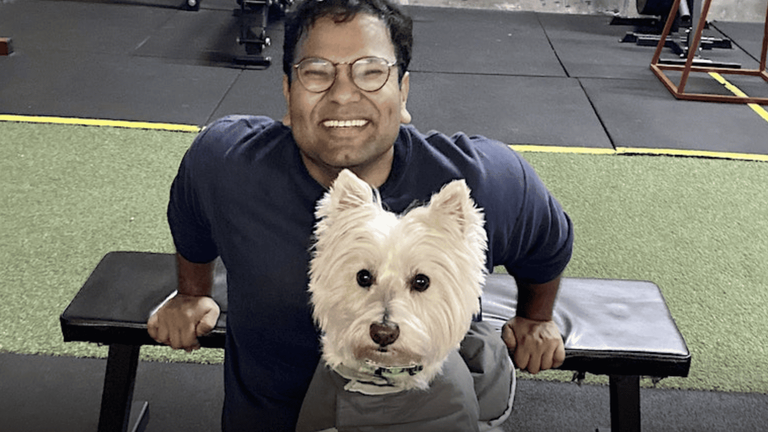 happy man at gym with dog