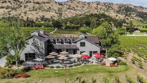 An aerial view of Goosecross Cellars nestled in a lush vineyard. - Dogtrekker