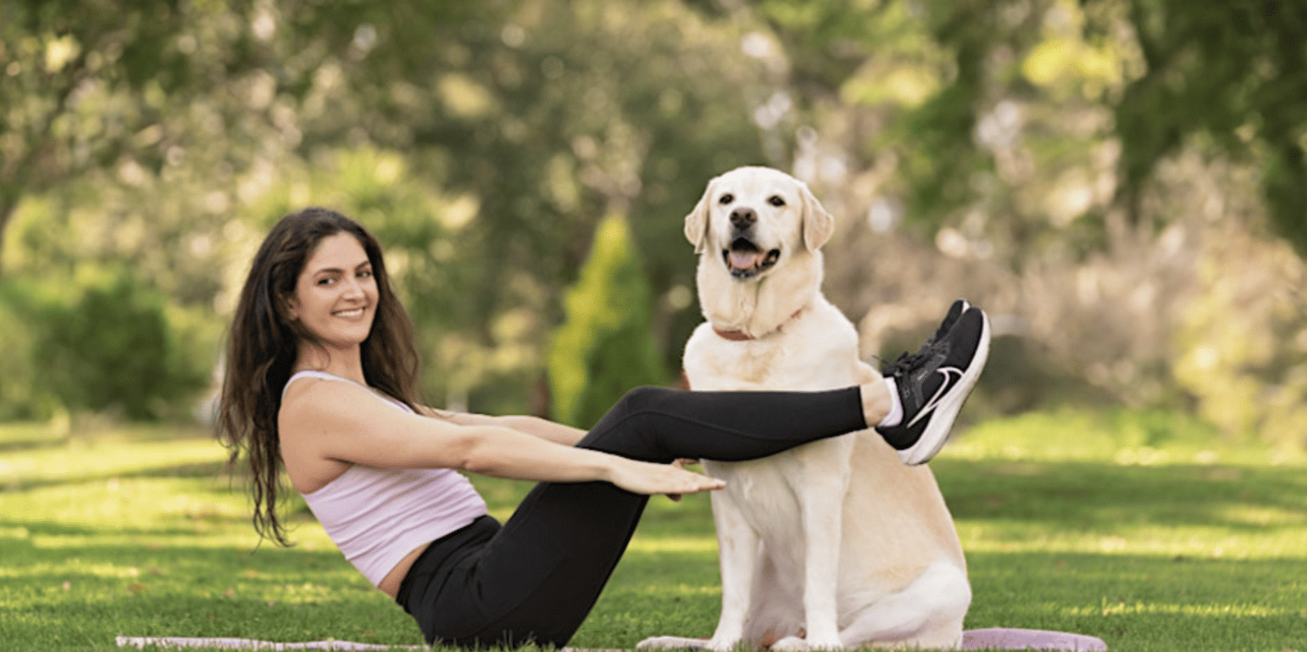 woman on yoga mat with dog