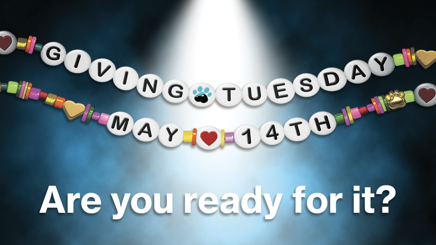 A vibrant graphic announcing "Spring Giving Tuesday" set for May 14th. Bright, joyful emojis dance around the letters in an endearing show of celebration. A spotlight pierces the dark, smoky backdrop.