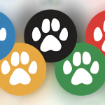 An image shows five colored circles in the shape of the Olympic rings, each containing a white paw print. The circles in blue, black, red, yellow, and green contrast against a soft-focus multicolored background.