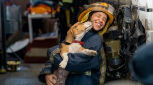 Woman firefighter holding a dog