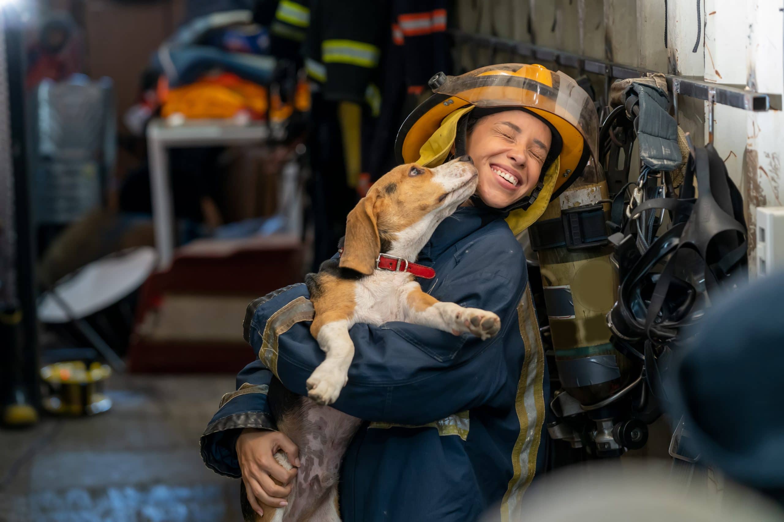 Woman firefighter holding a dog
