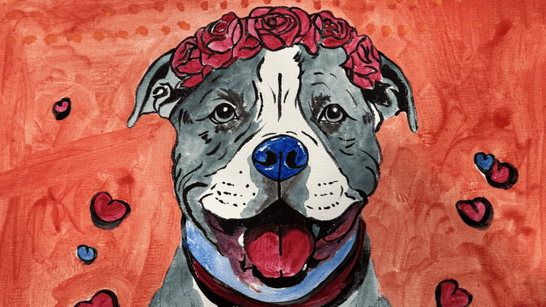 A vivid painting depicts a gray and white pit bull with a pink rose crown perched on its head, capturing the spirit of Pitty Paint Day. Set against an intense red backdrop, the scene is adorned with scattered red and blue hearts. The dog’s tongue lolls out in a happy expression, highlighting its joyful demeanor.