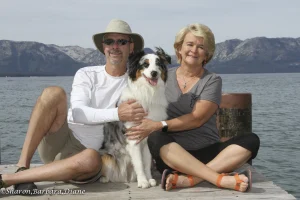 Wild dogs two people sitting with dog