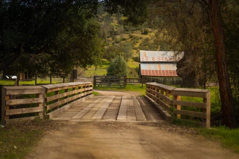 Wooden bridge entry to small ranch.