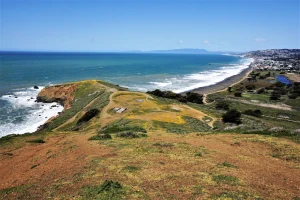 Aerial view of Laguna Salada Trail area at Mori Point in Pacifica, showing hiking trails, the coastal lagoon, and Pacific Ocean